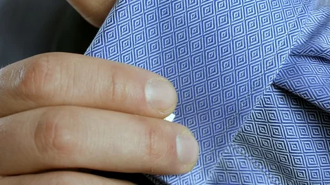 Man takes off cufflink cloce up Stock Footage 106256857