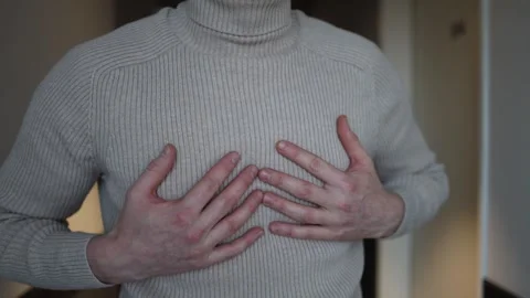 A man takes a deep, steadying breath, his hands raised slightly near his chest a Stock Footage 291849082