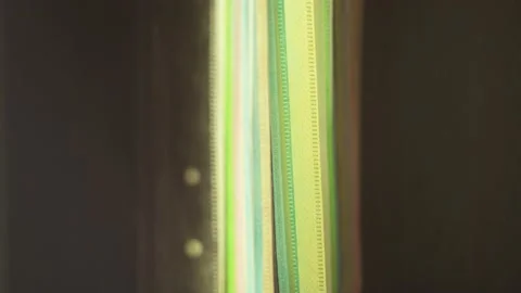 The man takes a disk from a shelf with lots of cd covers and cases Video stock 133365035