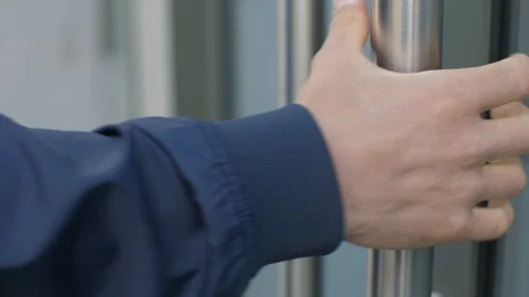 Man takes by the door handle Stock Footage 129802433