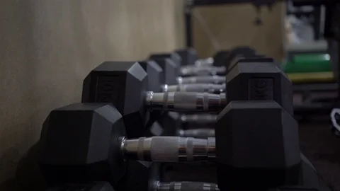 Man takes dumbbells in his hands Stock Footage 123799943