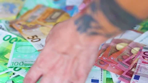 A Man Takes the Euros From Stack Stock Footage 144609885