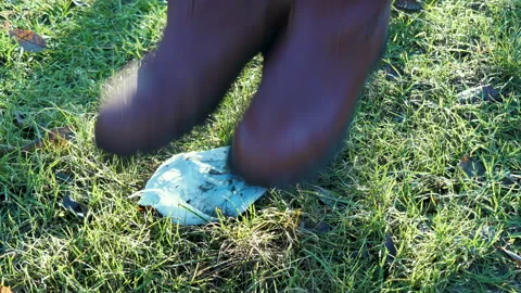 Man takes off face mask, throws it on ground and jumps on it with foot in park Stock-Footage 149313394