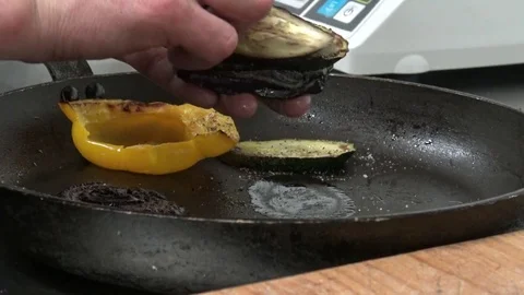 A man takes fried slices of vegetable from a pan and puts them together - 스톡 동영상 82682549