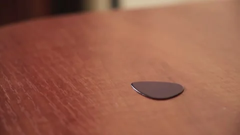 Man takes a guitar pick from the table Stock Footage 165003288