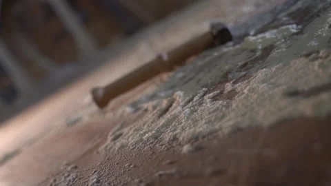A man takes a hammer that lies on a table surrounded by sawdust 4K footage Stock Footage 120699013