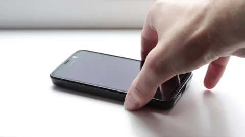 Man takes his smartphone from a table and puts it back Vídeos de archivo 66756394