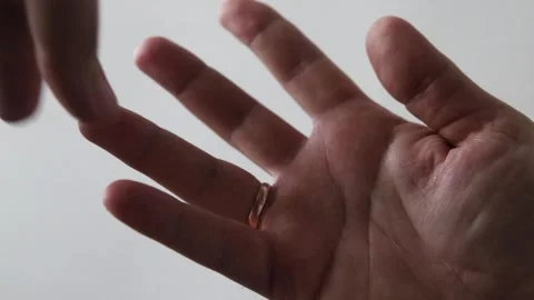 Man takes off his wedding ring Stock Footage 134289485