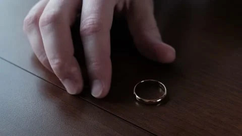 Man takes off his wedding ring from his finger Video stock 150316765
