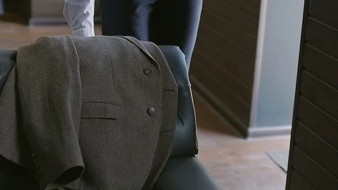 Man takes a jacket and puts it on his shoulder Video stock 79611016