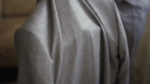 A man takes a jacket from a chair Stock Footage 167355637