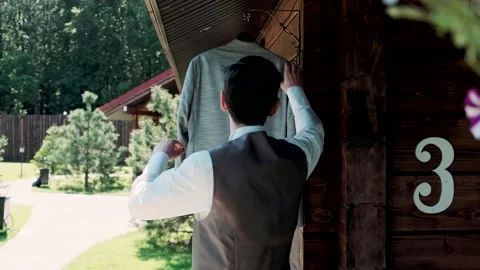 Man takes off a jacket from a hanger Video stock 135861343
