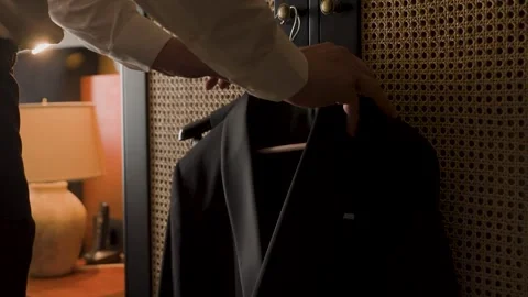 A man takes a jacket off a hanger Video stock 329249048