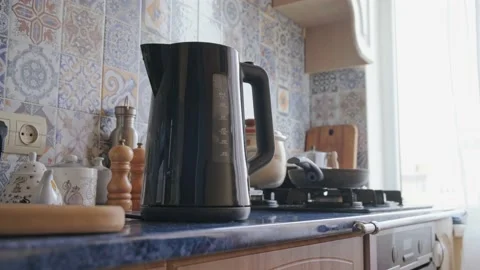 The man takes the kettle after boiling Stock Footage 165003082