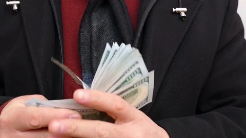 A man takes a large amount of 100 dollars out of his pocket and counts, Stock Footage 167136333