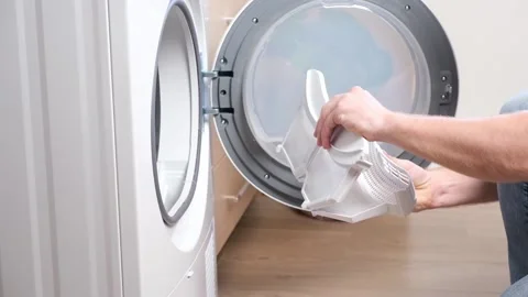 A man takes a lint filter out of dryer and cleans it from dust, lint, hair, wool Stock Footage 193738924