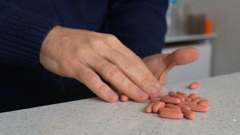 A man takes many pills, 4K 動画素材 124673053