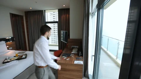 Man takes marker from table and quickly writes something on window glass Stock Footage 93505881