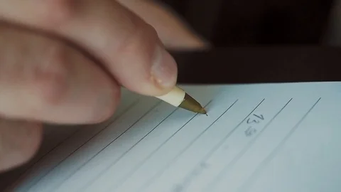A man takes notes in a diary Stock Footage 123014338