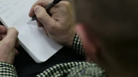 Man takes notes in a notebook Stock Footage 61145861