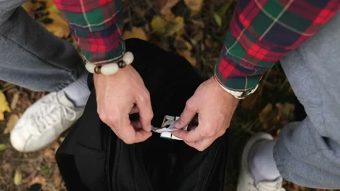 The man takes one scented incense stick out of his black backpack. Stock Footage 220415141