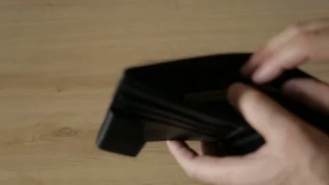 A man takes out banknotes from a leather purse Stock Footage 77265166