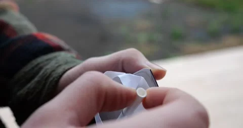 A man takes out a cigarette from a pack of cigarettes Stock Footage 231020505