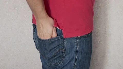 The man takes out a condom from the back pocket of his jeans. Concept of safe se Stock Footage 235706654