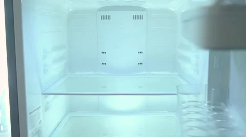 The man takes out of an empty fridge butter, poverty, single, close-up Stock Footage