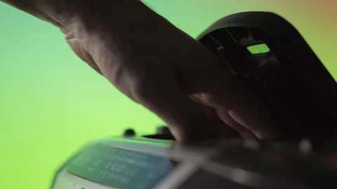A man takes out a laser CD disk from an old music player on a green background Stock Footage 145761311