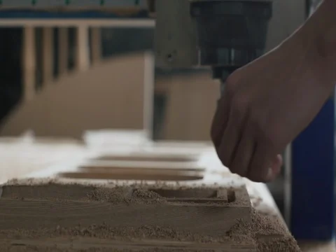 Man takes out products from automatic milling wood machine Stock Footage 73484673