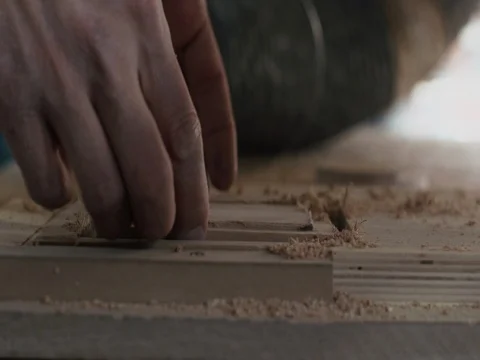 Man takes out products from automatic milling wood machine Stock Footage 73484749