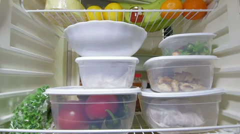 Man takes out stack of food plastic containers from fridge 스톡 동영상 33543721
