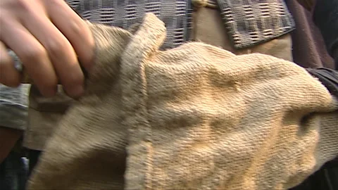 The man takes out the weapon hidden in the sack Stock Footage 276516350