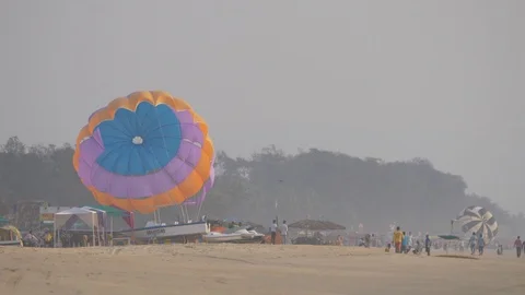 Man Takes Off With The Parachute On The Beach Stock Footage 105837480