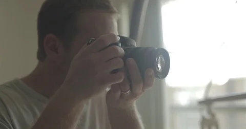 Man takes picture with digital camera at home Stock Footage 78037770