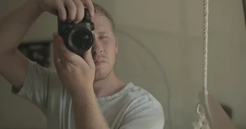 Man takes picture with digital camera at home Stock Footage 78037833