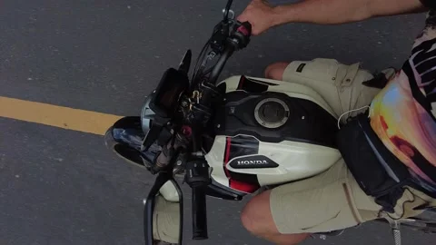 A man takes a picture of himself while riding a motorcycle in the tropics Stock-Footage 219658737