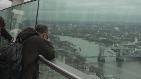 Man takes a picture of the sights of London and the London Bridge Stock Footage