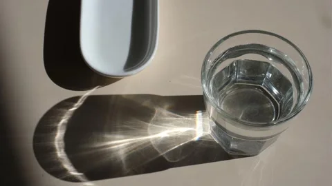 A man takes a pill and drinks water with it, close-up of hands, top view Stock Footage 318669875