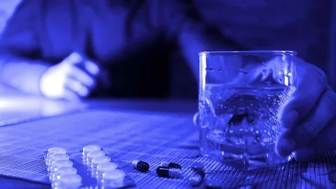 The man takes the pills from the table and drink their water. Medication closeup Stock Footage 71946648