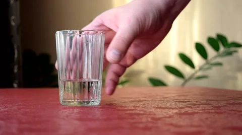 The man takes the pills from the table Stock Footage 55185608