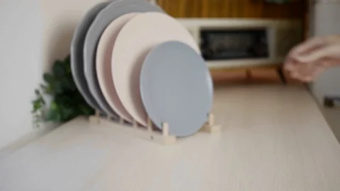 A man takes a plate in the bright kitchen. Stock Footage 121890449