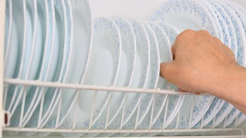 A man takes a plate from a shelf Stock Footage 100831330