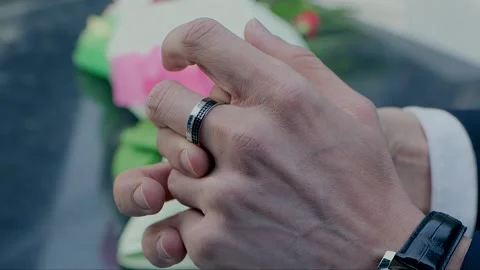 The man takes off the ring from his finger Stock Footage 261642407
