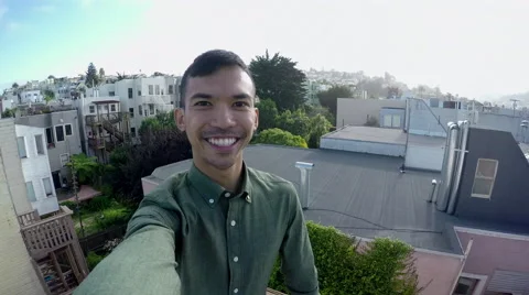 Man Takes A Selfie On Rooftop, With A View Of San Francisco In Background (4K) Stock Footage 50216155
