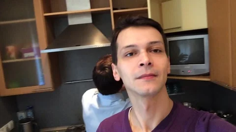 Man takes selfies and in background another man is looking for something Video stock 234856128