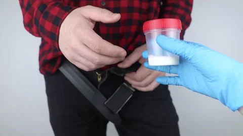 Man takes semen analysis. Spermogram. Concept. Male with his pants unbuttoned sy Stock Footage 190371163