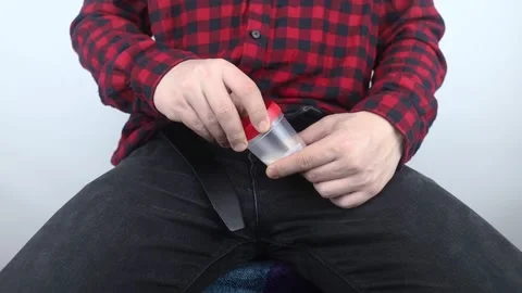 Man takes semen analysis. Spermogram. Concept. Male with his pants unbuttoned sy Stock Footage 190371288