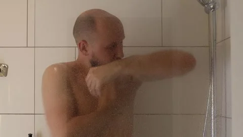 The man takes a shower. Stock Footage 243372386